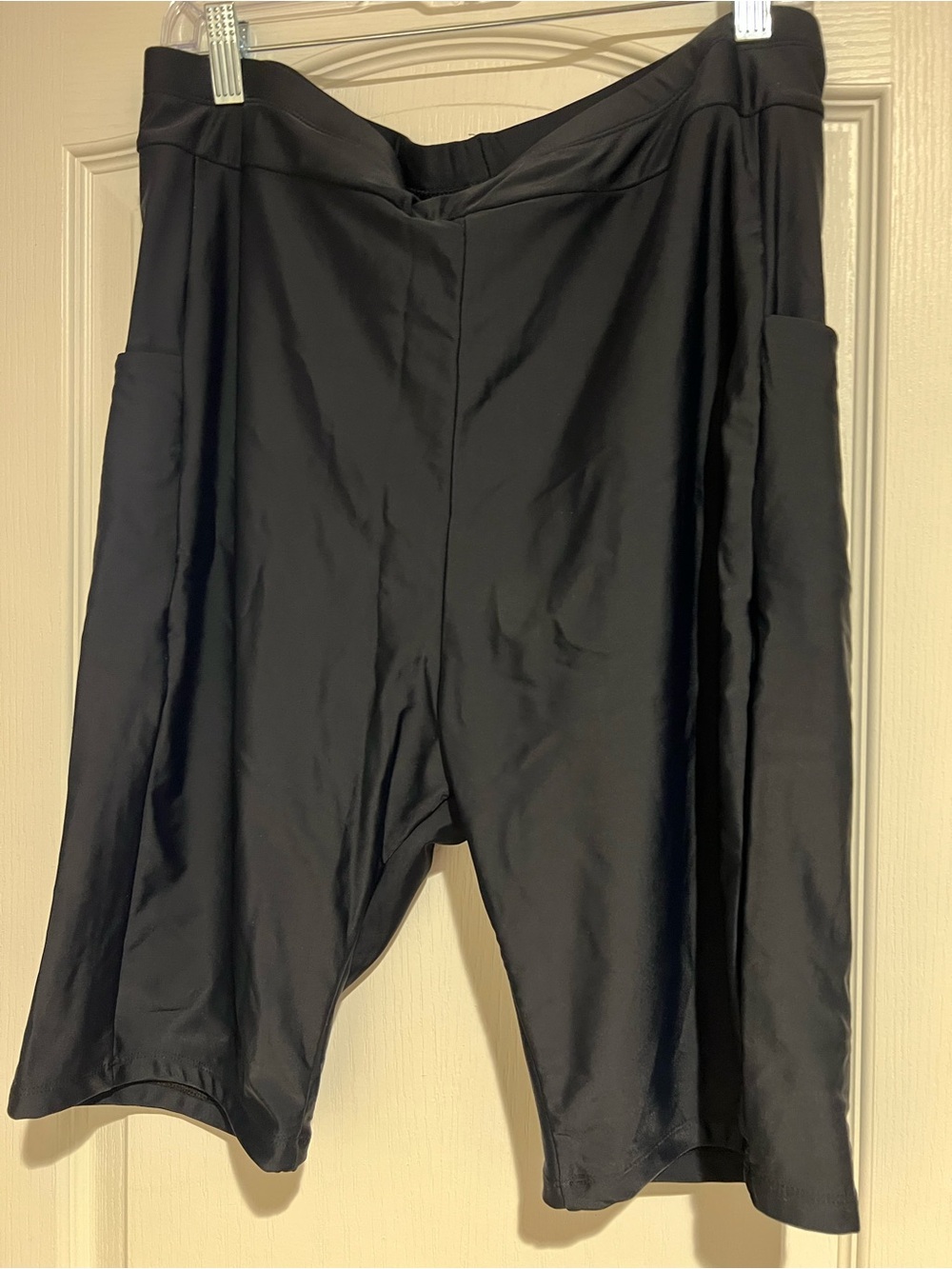 Women’s black swim suit shorts. With side pockets.